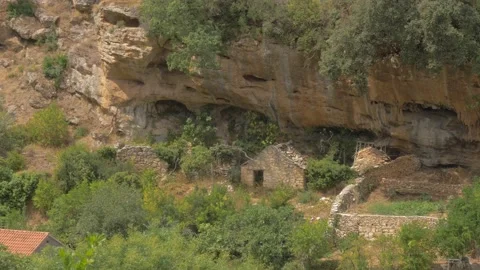 A hill with caves and old stone houses in front. Stock Footage 137874474