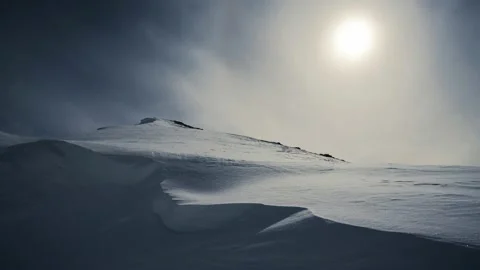 Hill covered in snow under harsh sunlight Video stock 220514339