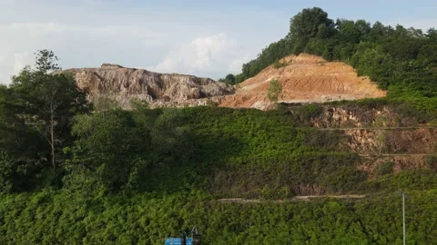 A hill that is eroded due to development and heavy rain at Puncak Perdana Stock Footage 230060839