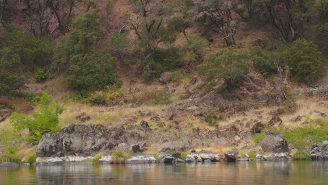 Hill on the other side of a river Video stock 103757792