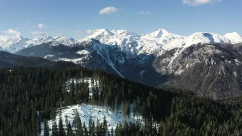 Hill Peak Surrounded With Dense Evergreen Spruce Forest and Winter Alps. Stock Footage 168251549
