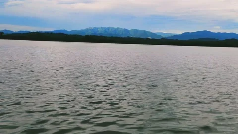 HILL SIDE VIEW OF BEAUTIFUL LAKE SUNSHINE FALLING ON HILLS TIMELAPSE CLIP Stock-Footage 136729993