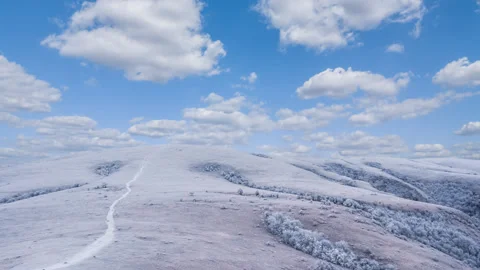 Hill in a snow under a cloudy sky, winter mountain time lapse scene Stock Footage 136721001