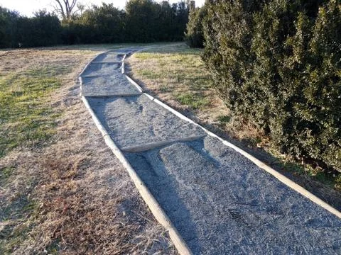Hill with stone or pebble path or trail and grass Stock Photos
