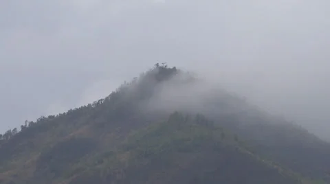 Hill surrounded by dark rainy clouds 스톡 동영상 38059248