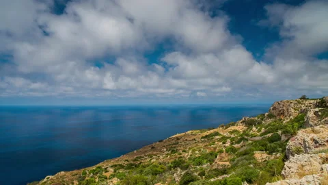 Up-hill view time lapse panoramic view of seascape and running clouds Video stock 140350437