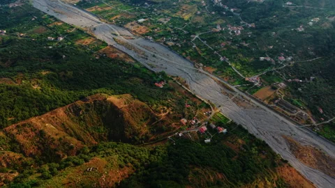 Hill village beside mining landscape and river valley countryside Stock Footage 329160664