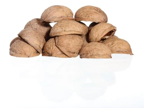 Hill of walnut's nutshells on white background Stock Photos