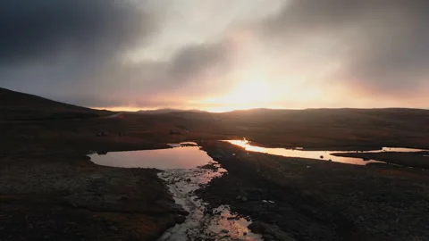 Hills and fields with lakes at bright sunset Stock Footage 255732713
