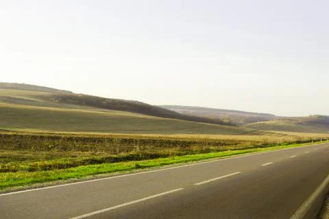 Hills in the fall with a freeway in the foreground. Stock Photos