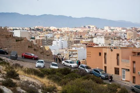 Hillside Cityscape with Mountain Backdrop Stock Photos