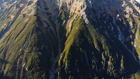 Hillside covered with grass, moss and rocks. Sunset in the mountains Stock Footage 120581973