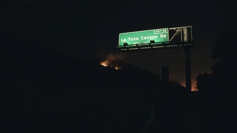 Hillside on Fire Behind Freeway Sign Video stock 79934623