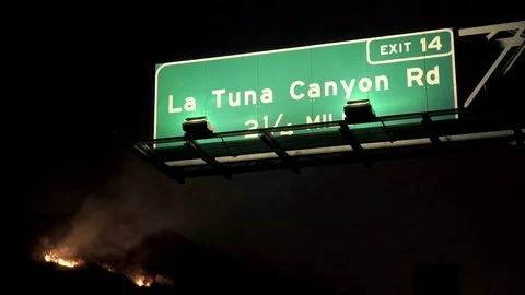 Hillside on Fire Behind Freeway Sign 動画素材 79934750