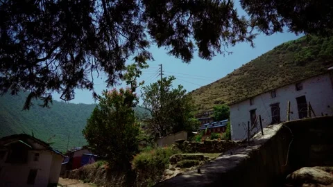 Hillside village seen through trees in mountainous region of Nepal Vídeos de archivo 342334844