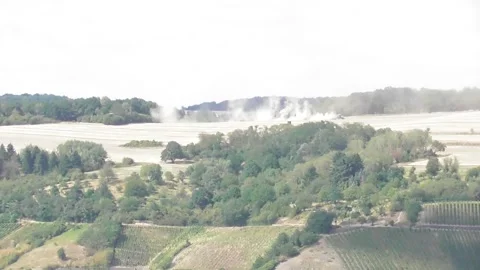 Hilltop field with a dust cloud above Stock Footage 340294502