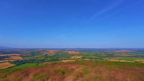 Hilltop field overview under blue sky with clouds in Ireland Stock Footage 340435927