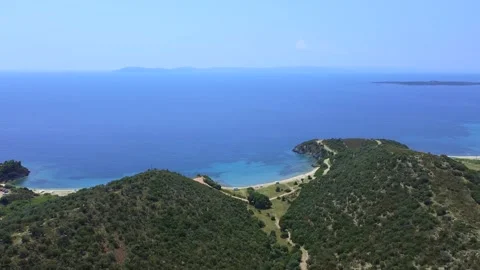 Hilly coast covered by pine trees and open blue sea in summer. Aerial view Stock Footage 138970898