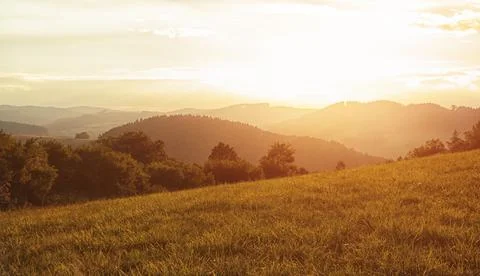 Hilly landscape in the setting sun Stock Photos