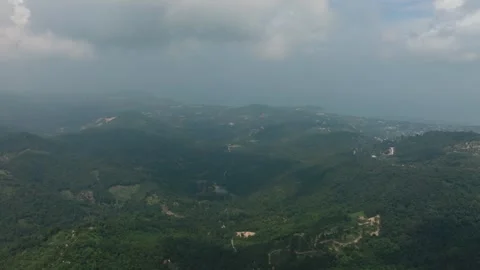 Hilly terrain with dense greenery and distant sea view. Ko Samui, Thailand. Stock Footage 310775627