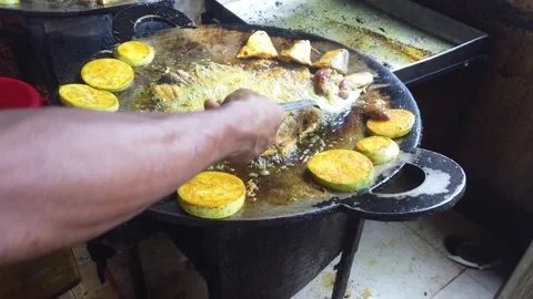 Hilsa fish are being fried in a large frying pan and eggplants, Bangladesh Stock Footage 302746868