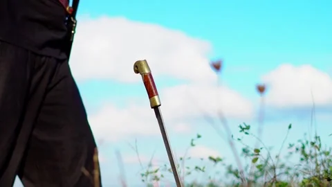 The hilt of a sword stuck in the ground Stock Footage 139438908