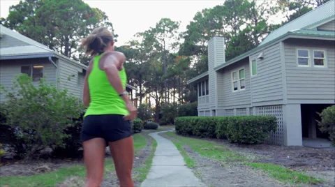 Hilton Head Runner runs by Condos Stock Footage 62892437