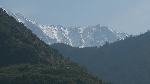 Himalaya mountain range, snow capped moutains and grassy hills - Wide Shot Stock Footage 126656524