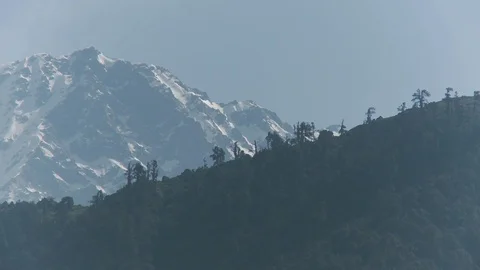 Himalaya mountain range, snow capped moutains and grassy hills - Mid Shot Stock Footage