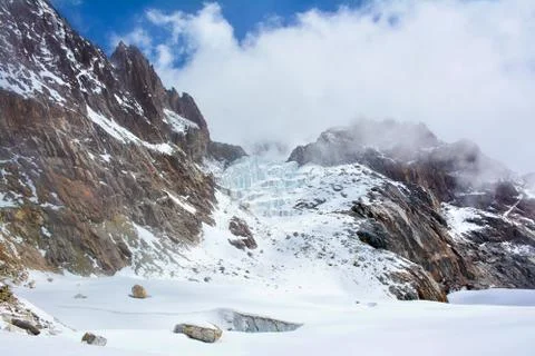 Himalayan mountains wrapped in clouds. View from the Cho-La pass, Nepal. Stock Photos