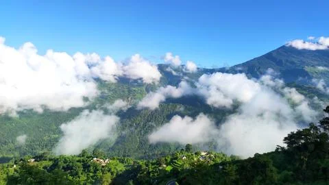 Himalayan valley landscape with clouds and lush mountains 스톡 사진