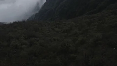 Himalayas Cloudy reveal forward panning up, 4K Drone Stock Footage 204879001