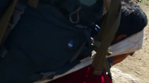 Himalayas Nepal porter fixes load and continues walking down footpath outside Vídeo Stock 45208757