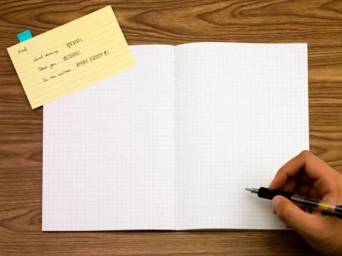 Hindi; Learning New Language Writing Words on the Notebook Stock Photos