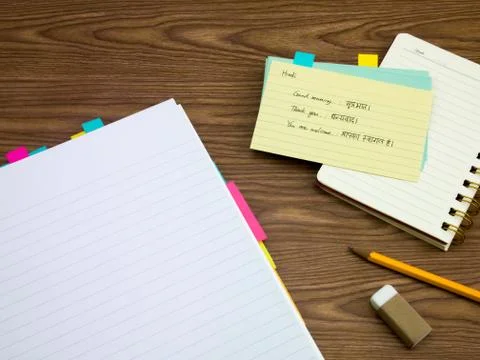 Hindi; Learning New Language Writing Words on the Notebook Stock Photos