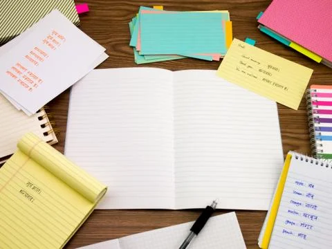 Hindi; Learning New Language Writing Words on the Notebook Stock Photos