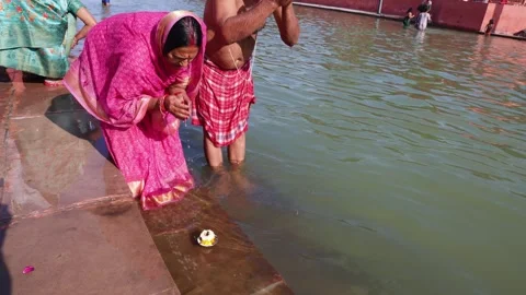 Hindu Devotee Offering Prayer During Sacred Holy rituals at Sarayu River bank Stock Footage 340814788