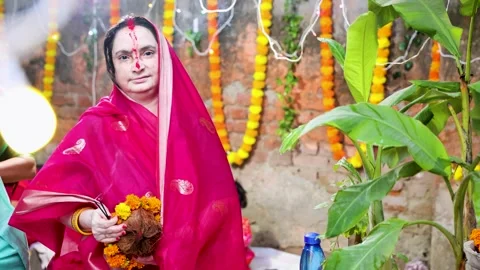 Hindu devotee performing chhath puja with sacred offerings outdoors Stock Footage 316674983