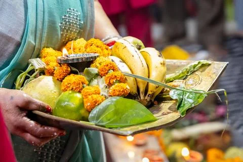Hindu devotee performing offerings ritual during chhath puja celebration Stock Photos