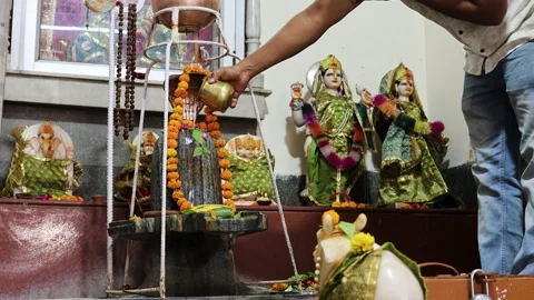 Hindu devotee performing shivling abhishek ritual inside indian temple with.. Stock Footage 335742647