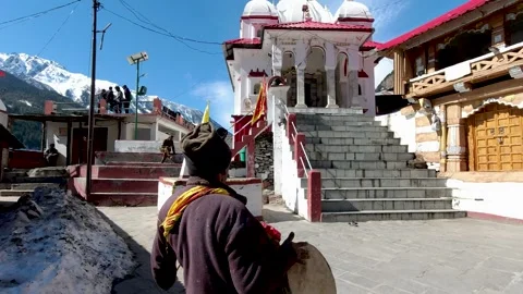 Hindu Devotee playing religious drums outside Gangotri Temple Dharali area Stock Footage 250891591