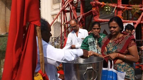 Hindu devotees accept prasad(offering) at Bhagyalakshmi temple in India Stock Footage 83637679