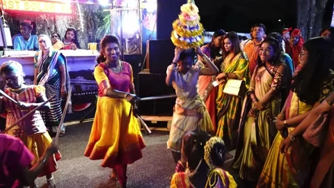 Hindu devotees dance with peacock costume, pot on head, stick dance Stock Footage 130870943
