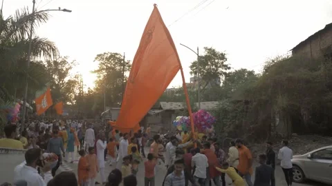Hindu devotees hosting religious saffron flag during religious Ram Rath Video stock 213444624