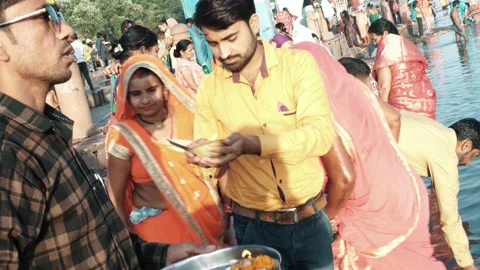 Hindu Devotee's Performing Hindu Puja Rituals In River Stock Footage 133925337