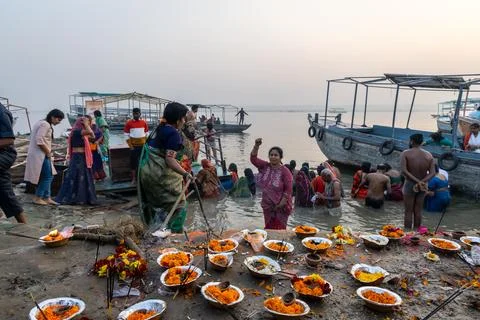 Hindu devotees performing sacred river rituals at crowded holy varanasi ghat Stock Photos