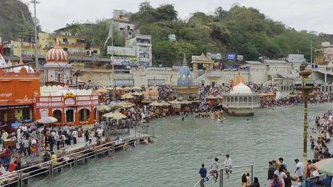 Hindu devotees taking a religious dip in the sacred waters of Ganga river at har Stock Photos
