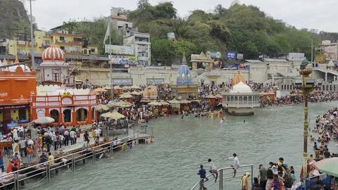 Hindu devotees taking a religious dip in the sacred waters of Ganga river at har Stock Photos