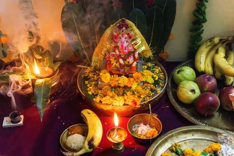 Hindu devotional setup featuring ganesha idol flowers fruits and ceremonial.. 写真素材