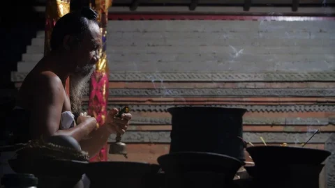 Hindu priest praying at night, preparing for Melukat Mebayuh Ceremonial, Bali Stock Footage 140295645